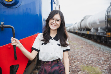 portrait happy asian woman lady on railway train station locomotive industry leisure relax smile image