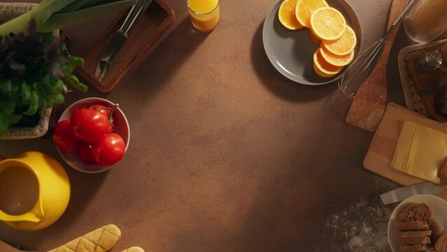 Top Down View on an Empty Kitchen Table. Dining Table with Utensils, Fresh Vegetables, and Fruits, Essentials of Healthy Breakfast. Background Concept for Food Business, Stores and Restaurants