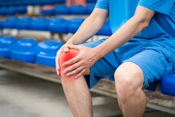 Obraz na płótnie Canvas Diseases of the knee joint, bone fracture and inflammation, athletic man on a sports ground after workout suffering from pain in leg and doing self-massage