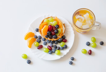 cupcakes with fruits and cold healthy drink on white  table
