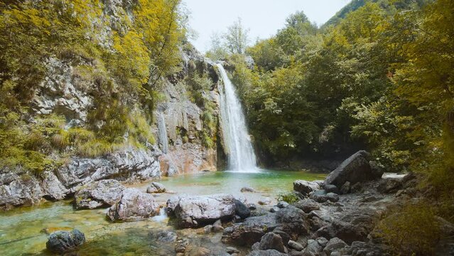 Small waterfall between colorful trees