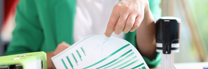 Manager working with financial reports on office desk.
