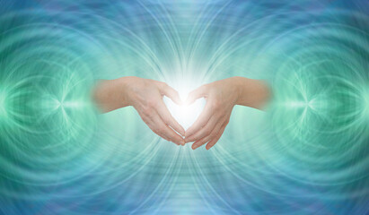 Sending out heart-centred Scalar Healing  - Female hands making a heart shape against symmetrical ...