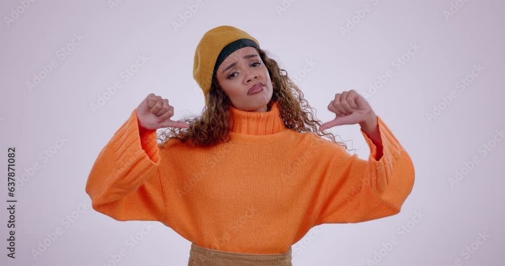 Canvas Prints Face, frown and thumbs down by sad woman in studio for no, bad or negative feedback on grey background. Portrait, hand and model with emoji vote for fake news, reject or wrong, opinion or choice fail