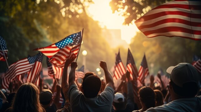 large group of people in an outdoor setting holding American flags, and have their hands raised in the air, they are cheering and celebrating national holiday