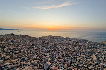 A panoramic  view of 
sunset above the mediterranean sea during the golden hour .Overlooking view of the the mediterranean sea during sunset in Canastel forest Oran Algeria