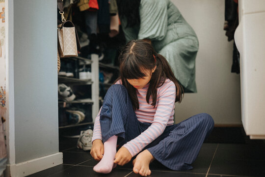 Mother And Daughter Getting Ready To Go Out