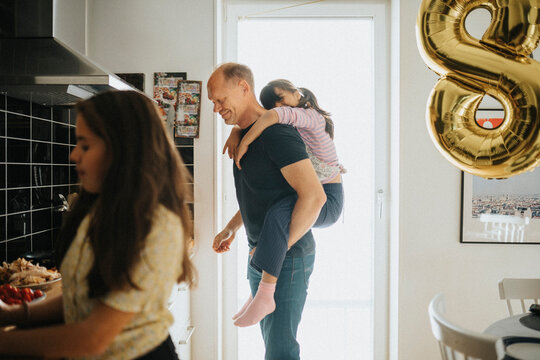 Father and daughters getting ready for birthday party