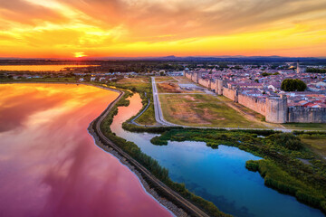 The pink salt lakes and the medieval walled Old town of Aigues-Mortes, Camargue, France - 637889258