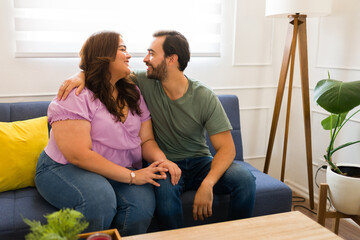 Smiling couple in love embracing talking about their feelings