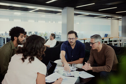 Group Of Business People Having Meeting In Lobby