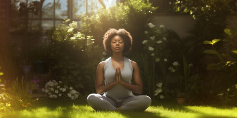 Young African American woman practicing yoga in a garden on a sunny day