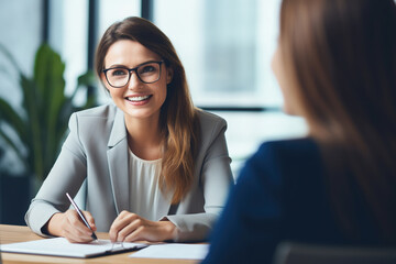 Female hiring manager interviewing a job candidate in her office