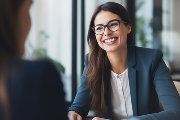 Female hiring manager interviewing a job candidate in her office