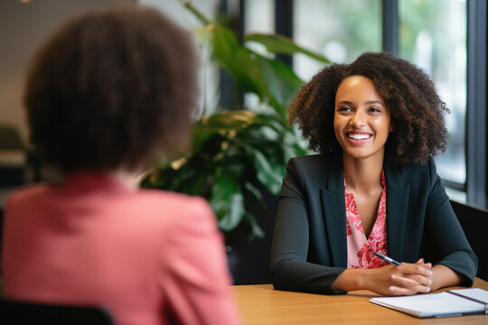 Female hiring manager interviewing a job candidate in her office
