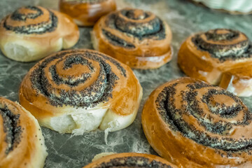 Homemade roll bun with poppy seeds and delicious crispy crust and sugar. Close-up. Selective focus