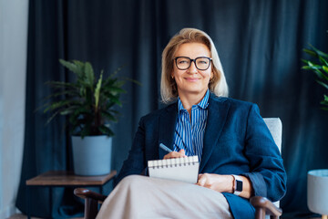Portrait of smiling 50's stylish, confident mature businesswoman, middle aged company ceo director,...