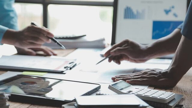 Financial Business team present. Business man hands hold documents with financial statistic stock photo, discussion, and analysis report data the charts and graphs. Finance Financial concept