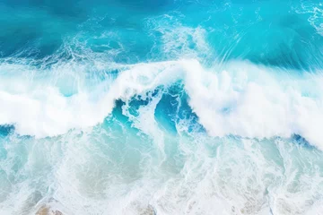 Zelfklevend Fotobehang a beautiful blue ocean with crashing waves from an aerial perspective © Virginie Verglas