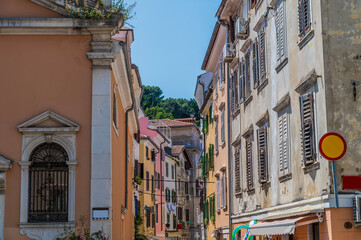 A view up a colourful street in the town of Piran, Slovenia in summertime