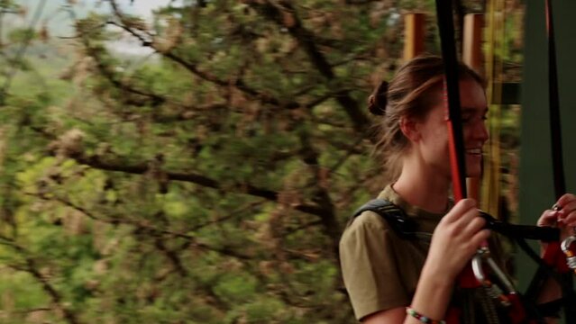 A young girl descended on a zip line to the lower base overwhelmed with emotions