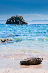 A stone in the water of the Atlantic ocean on a sunny day, cies galicia