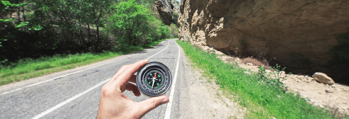 man hand compass in road
