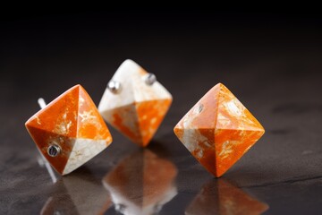 A colorful pair of earrings on a tabletop
