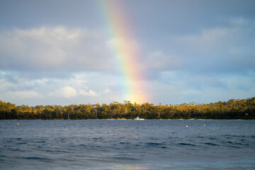 rainbow over the ocean and the australian bush