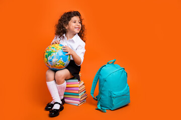 Photo of cute schookid sit pile encyclopedia hold world globe backpack look season school discount...