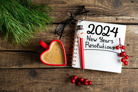 New year resolutions 2024 on desk. 2024 goals list with notebook, coffee cup on wooden table. Resolutions, plan, goals, action, checklist, idea concept. New Year 2024 resolutions, copy space