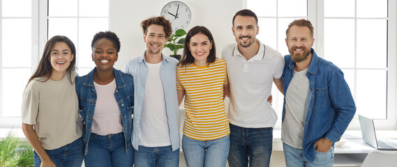 Happy diverse friends or coworkers. Banner with a group portrait of cheerful young multiracial...