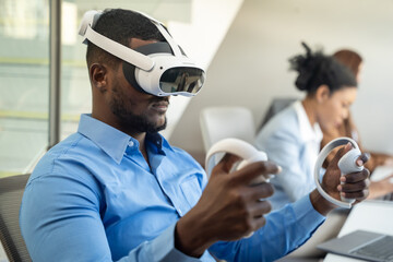 Businessman wearing VR and using to work. He using hand to control data while wearing VR goggles.