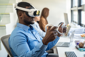 Businessman wearing VR and using to work. He using hand to control data while wearing VR goggles.