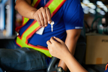 worker giving forklift vehicle key to coworker in the factory © offsuperphoto