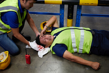 senior worker fell over and his head is bleeding on the floor in the factory