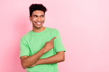 Photo of dreamy funny man dressed green t-shirt looking showing thumb empty space isolated pink color background