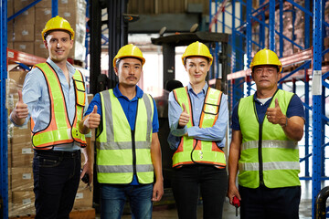 group of workers thumbs up pose after success work in the warehouse storage