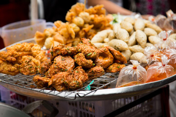 Fried snacks at food stall on the streets of Bangkok, Thailand.