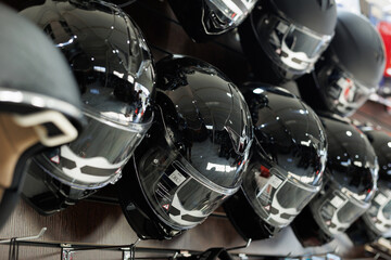 Off-road protective motorcycle helmets are sold in the store. - obrazy, fototapety, plakaty