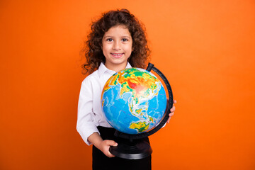 Photo of cute adorable school girl hold big globe learn continents country in class isolated bright color background