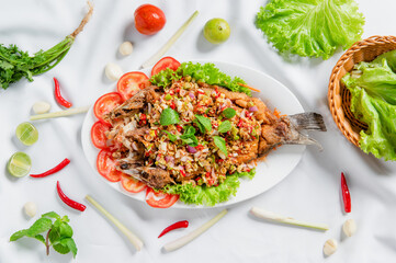Fresh tasty grilled sea bass fillet with tomato
 and vegetable salad close-up on a plate on the white table