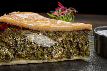 Savory kish pie slice with fresh herbs and cheese, close-up