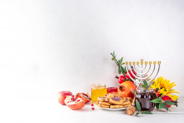 Rosh hashana jewish holiday background with red apples, honey, pomegranate, Shofar and goblet, jewish New Year holiday with traditional symbols. Happy Rosh hashana greeting card 