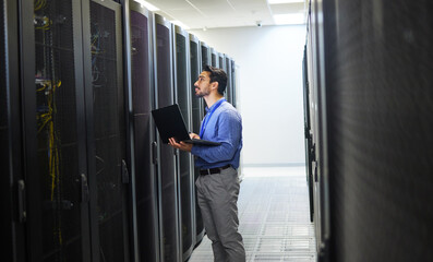 Man, engineering laptop and server room, data center inspection or system solution for...
