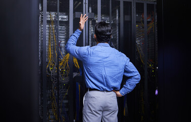 Server room, stress or male technician with hardware or cables for cybersecurity glitch or machine problem. Doubt, risk or back of confused man fixing network for information technology or IT support