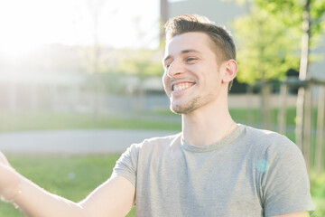 Portrait of young caucasian smiling man outdoors carefree