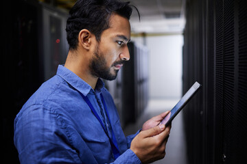 Tablet, man and reading in server room of technician programming at night. Information technology,...