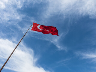 Turkish flag hoisted on flagpole , red turkish flag in front of blue sky - obrazy, fototapety, plakaty