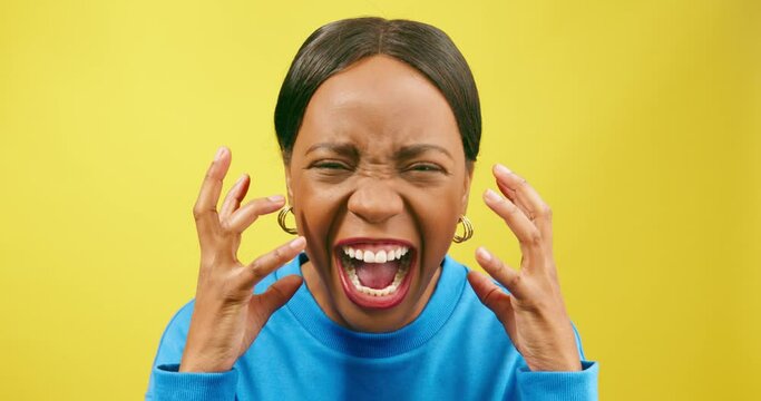 Angry woman screams and yells with hand gestures, yellow studio